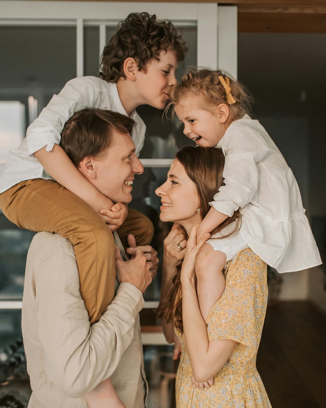 A couple with a young child sitting on the father's shoulders
